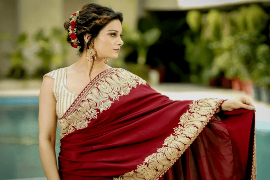 A women with Red and Golden Embroided Saree