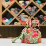 Art Raw Silk Aari Jaal Embroidered Sage Green Potli Bag front